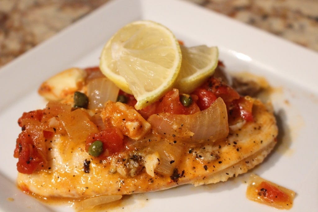 Mediterranean Tilapia- Quick and easy recipe that tastes as good as it looks! Flaky fish in an aromatic broth of lemon, wine, tomatoes, garlic and capers. -thesaltedpepper.com