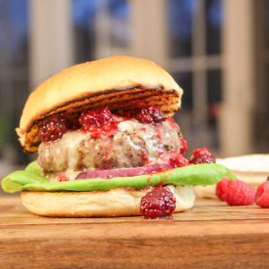 brie and berry burger on cutting board