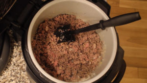 Ground beef almost cooked in the Ninja Foodi