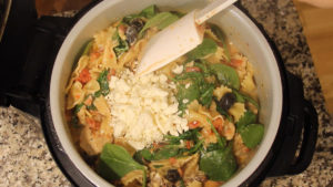 adding feta and spinach to inner pot of Ninja Foodi