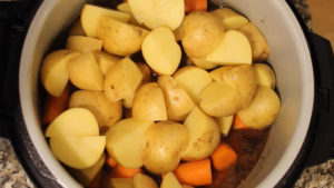 Carrots and potatoes in the inner pot with liquid