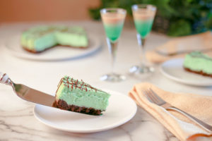 Mint Cheesecake being served on a white dish