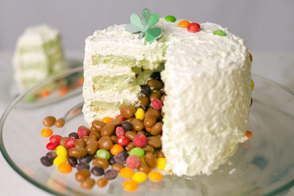 Pistachio Avalanche Cake on a glass cake stand