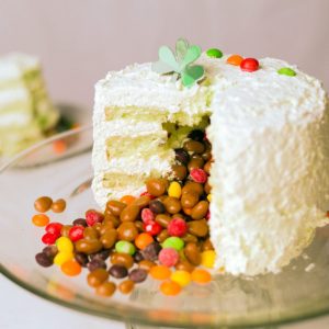 Pistachio Avalanche cake on a glass cake stand