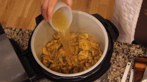 Deglazing the Ninja Foodi pot with chicken stock
