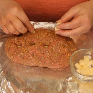 Putting the cheese cubes into the meatloaf