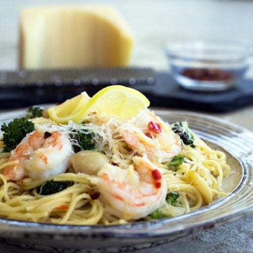Easy Shrimp Scampi on a plate with a lemon wedge on top