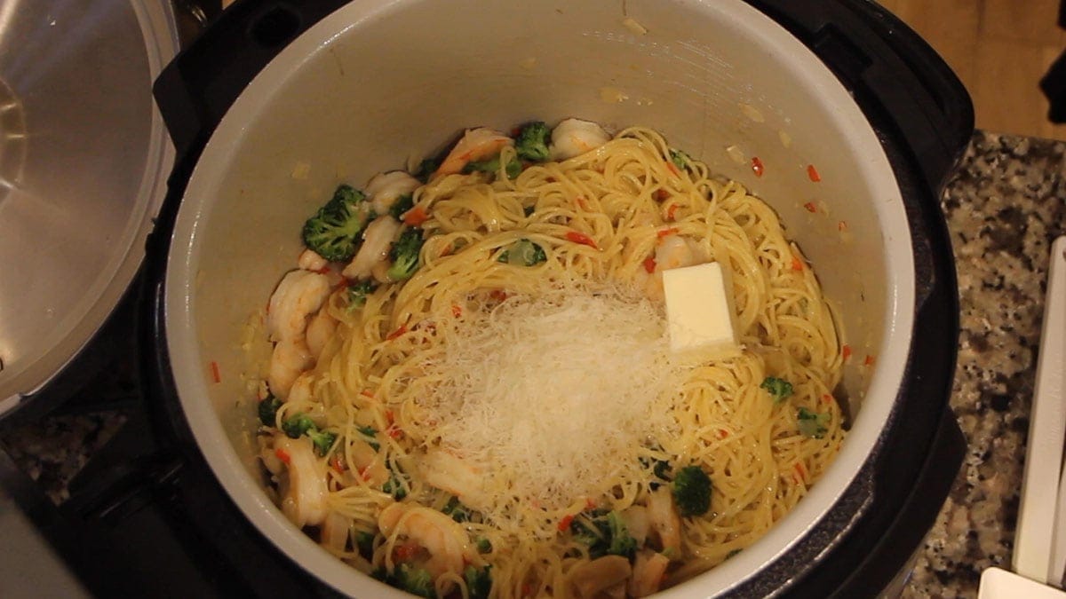 Adding Parmesan cheese to easy shrimp scampi