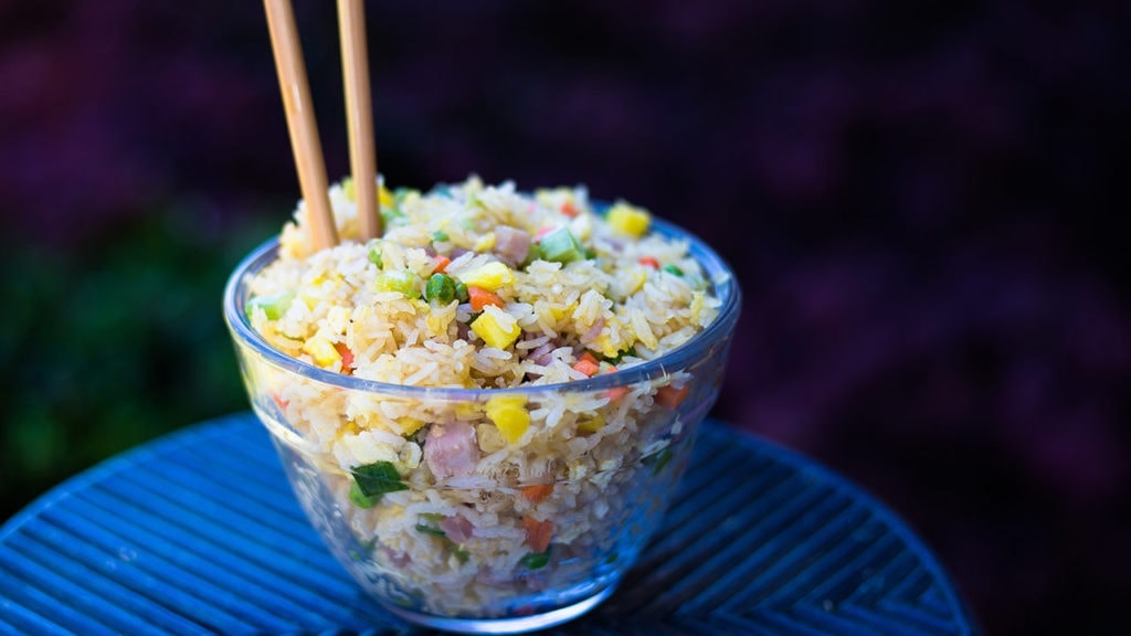 Hawaiian Fried Rice in a glass bowl with chopsticks