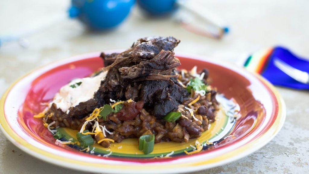 Mexican Pot Roast with rice and beans on a colorful plate