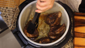 Searing the Mexican Pot Roast in the inner pot of the Ninja Foodi