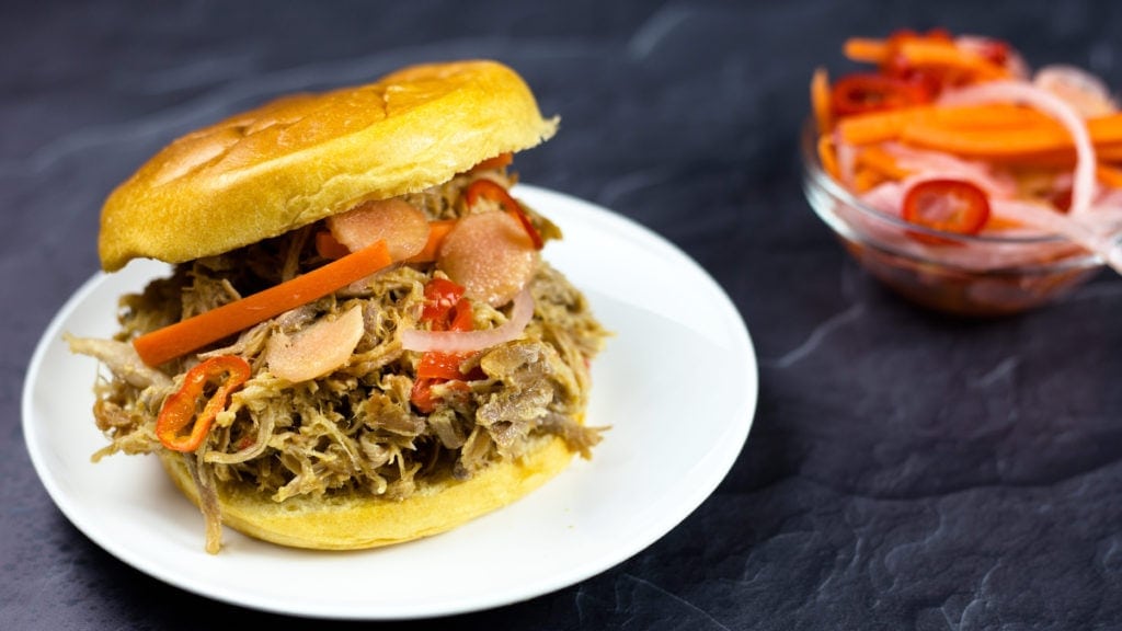 Asian pulled pork on a bun with pickled vegetables