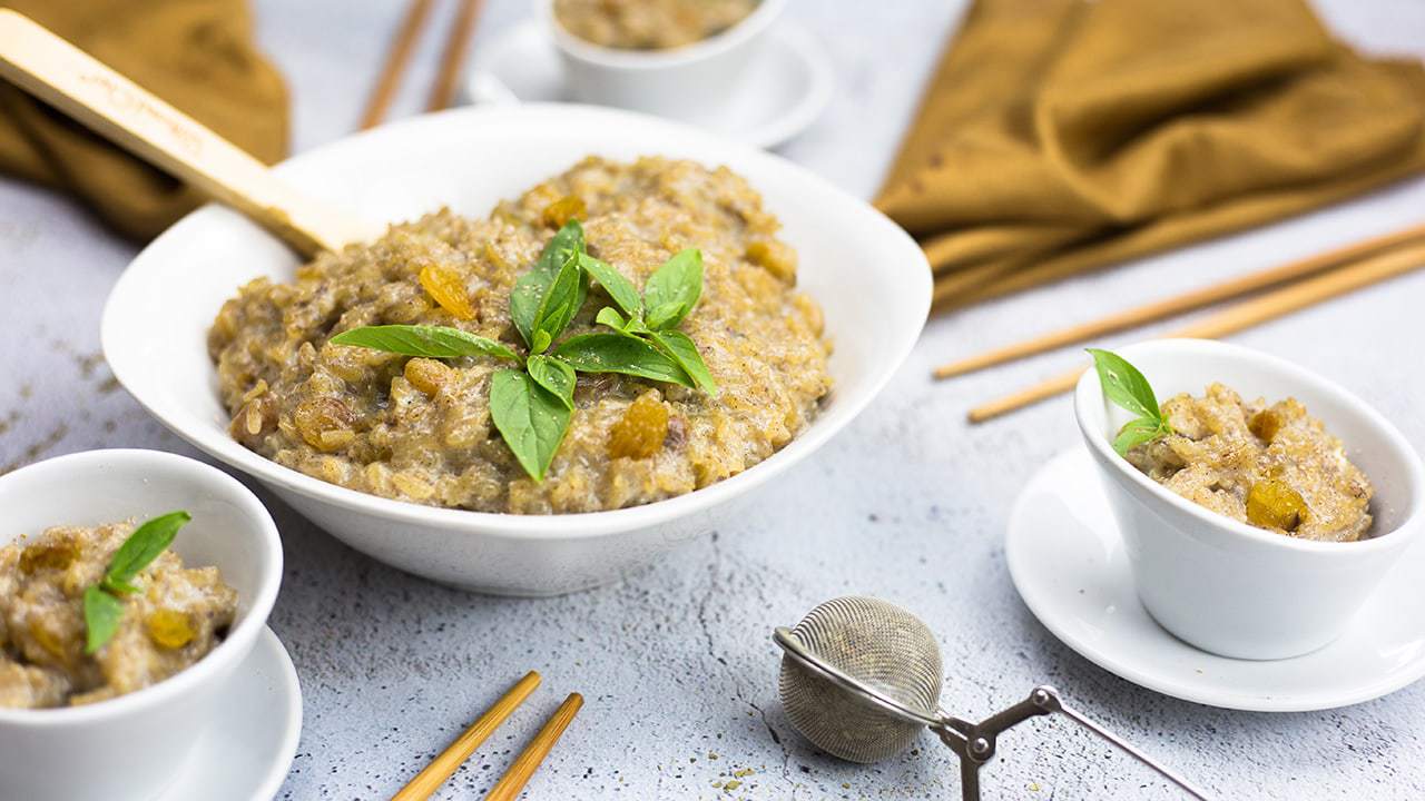Jasmine Rice Pudding in a bowl with Thai Basil on top