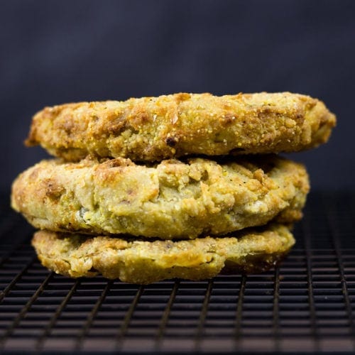 three fried green tomatoes on a cooling rack