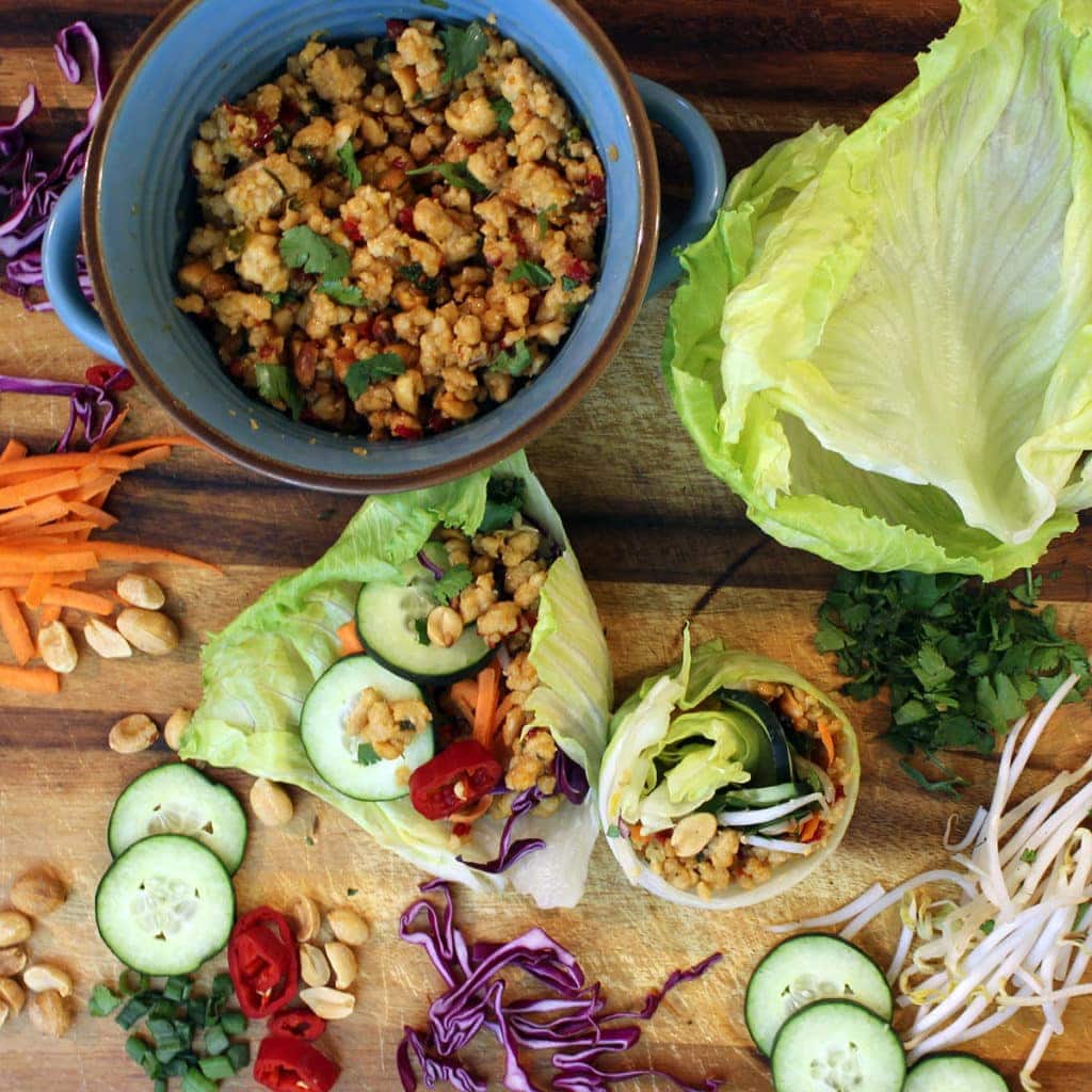 Asian lettuce wraps on cutting board with toppings