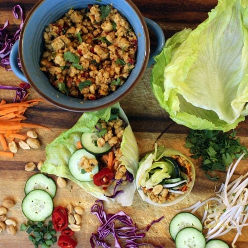 Asian lettuce wraps on cutting board with toppings