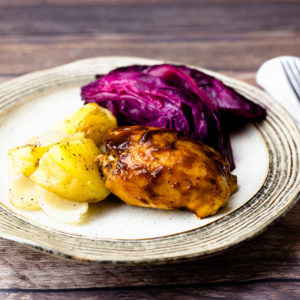 BBQ Chicken, potatoes, purple cabbage on a plate