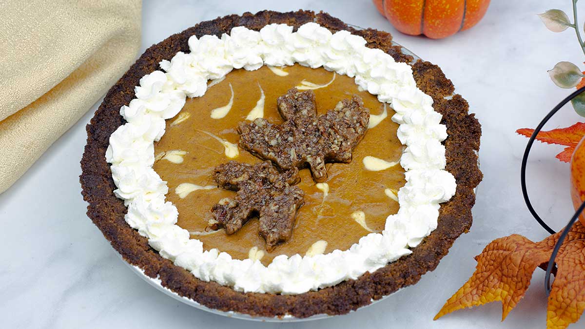 layered pumpkin cheesecake pie with decorations