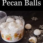 Pecan Balls in a container with a few on the table