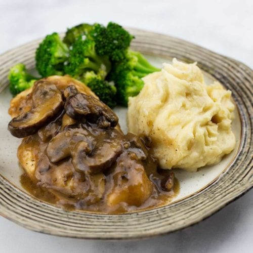 Chicken Marsala with mashed potatoes and broccoli on a plate