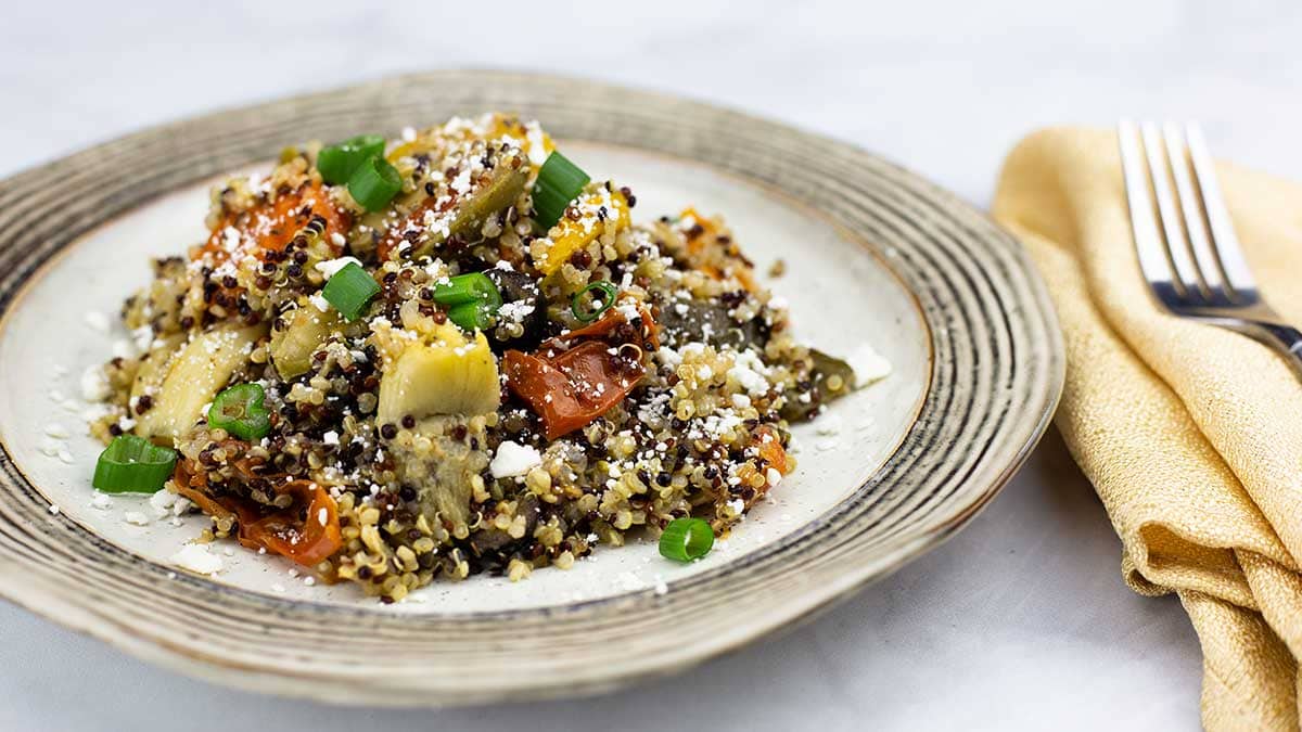 Mediterranean Quinoa with Vegetables on a plate with garnish