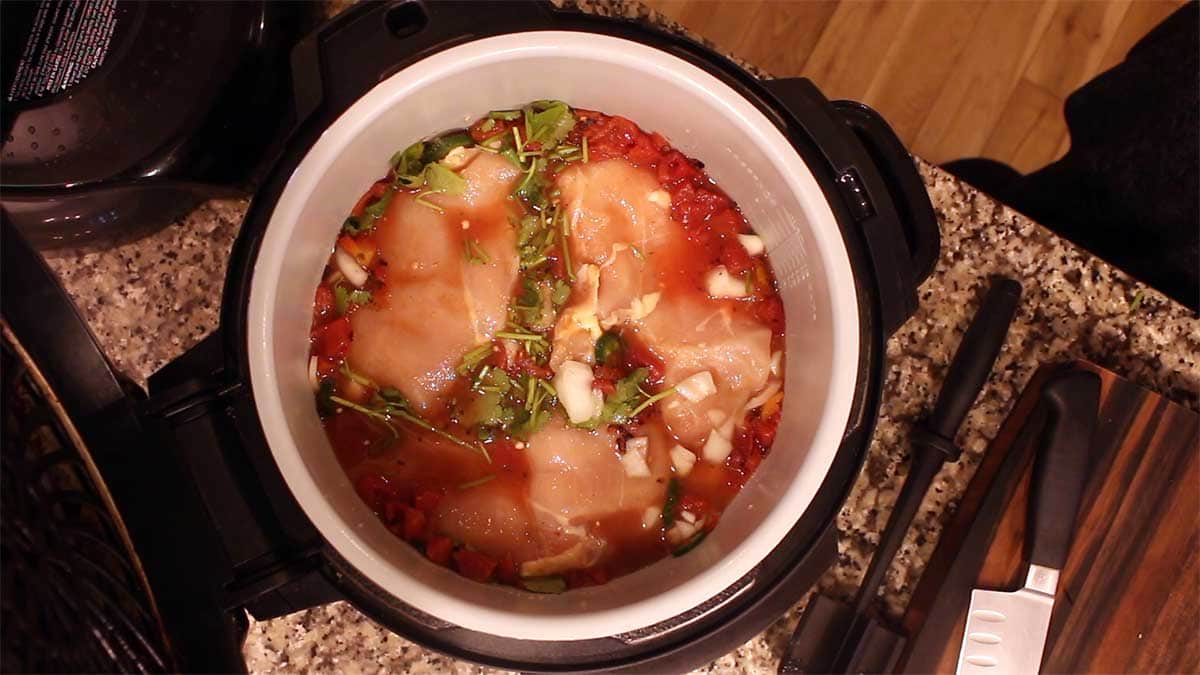 Adding chicken to the inner pot 