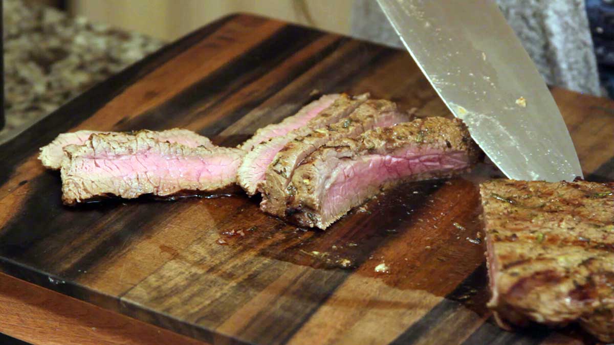 Grilled London Broil sliced on a cutting board