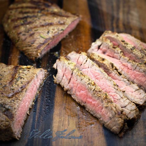 Grilled London Broil Medium Rare sliced on a cutting board
