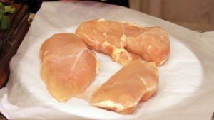Frozen chicken breasts on a plate