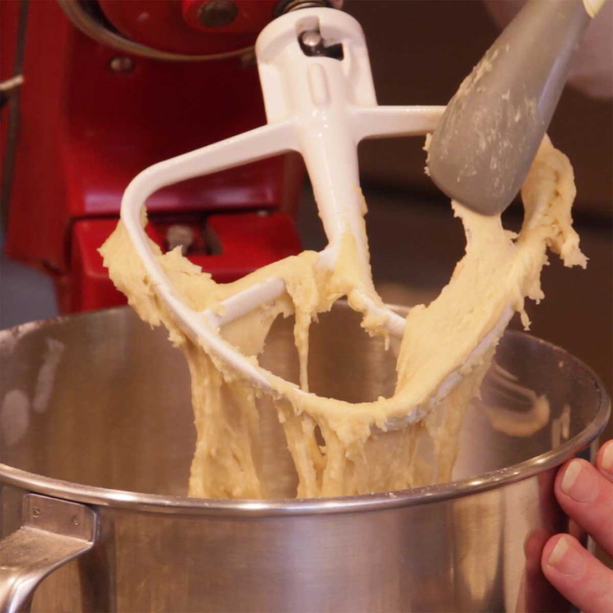 showing dough on the mixing paddle that is too sticky