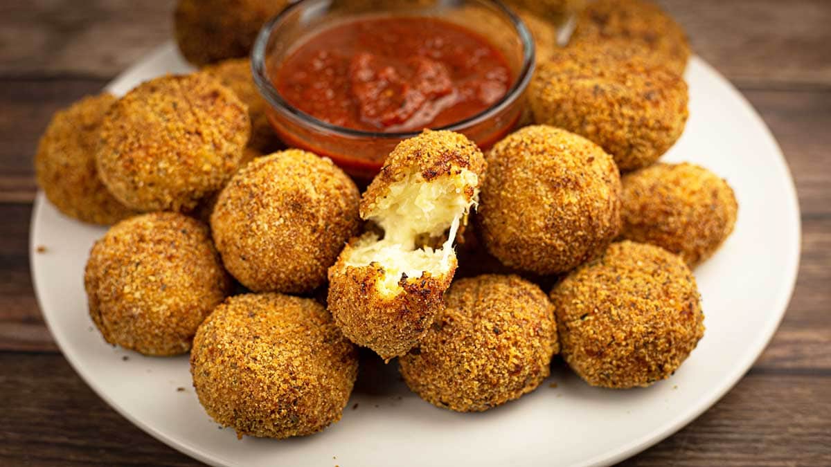 Cauliflower Arancini balls on a plate with marinara