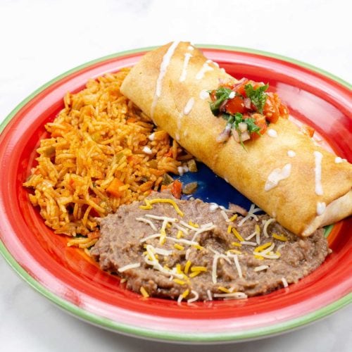 Air-Fried Chimichanga with mexican rice and beans on a colorful plate
