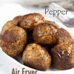 Air Fryer Meatballs in white bowl with a fork and napkin towards the back