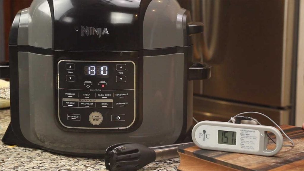 Pampered Chef Probe Thermometer sitting on cutting board with probe inside the Ninja Foodi
