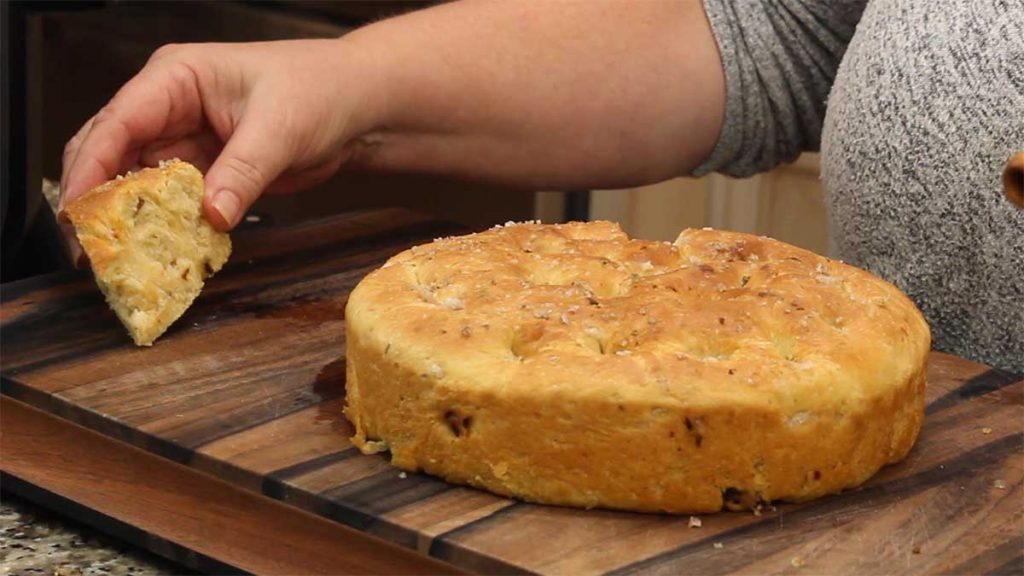 cutting and serving focaccia bread