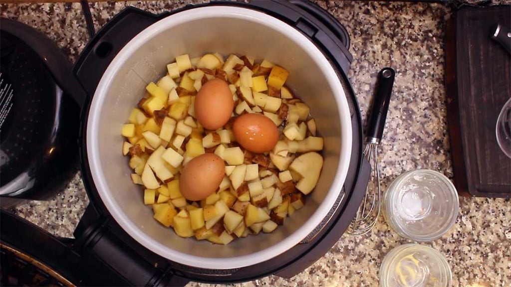 adding eggs on top of potatoes before pressure cooking