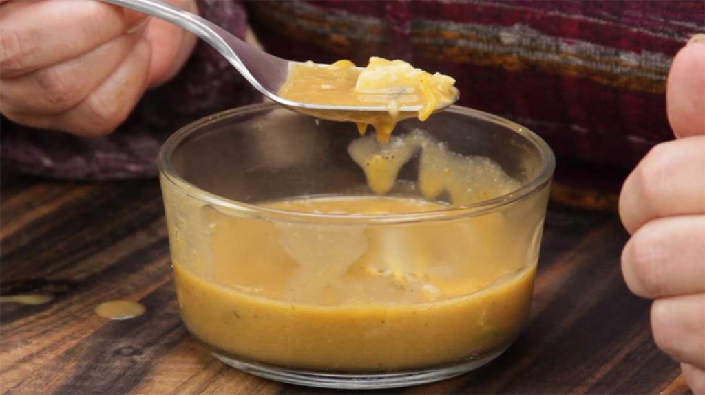 Taking a spoonful of creamy enchilada soup