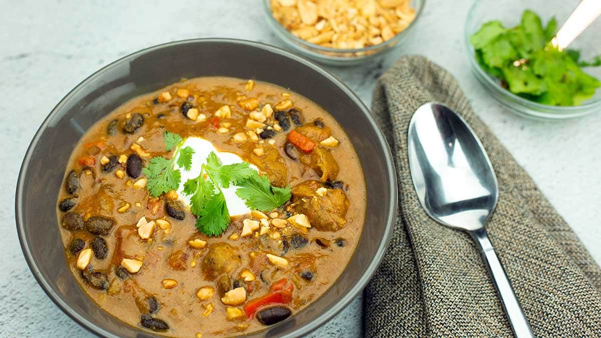 curry chicken chili in a bowl with garnish