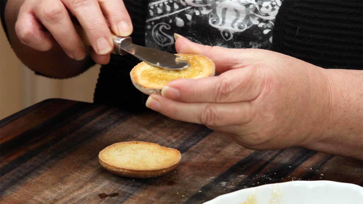 spreading the banana jam on an english muffin