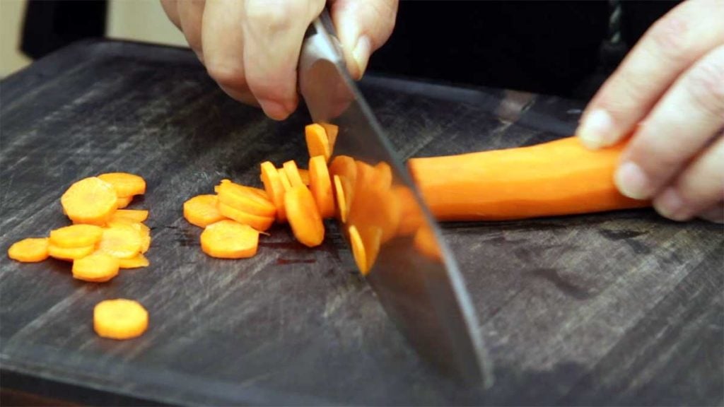 thinly slicing the carrots for greek meatball soup