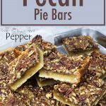 pecan bars cut and piled up on a sheet pan