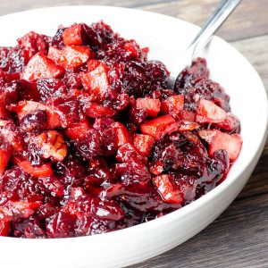 cranberry apple chutney in a white bowl with a spoon
