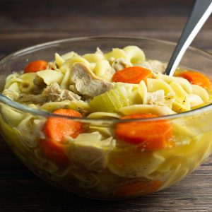 homemade chicken noodle soup in a glass bowl