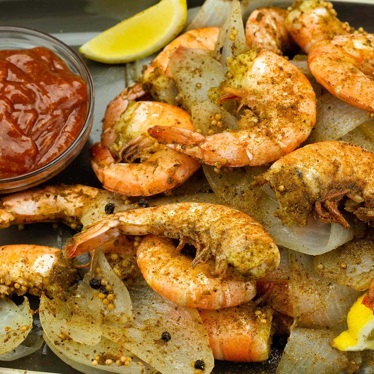 maryland style steamed shrimp on a platter with cocktail sauce