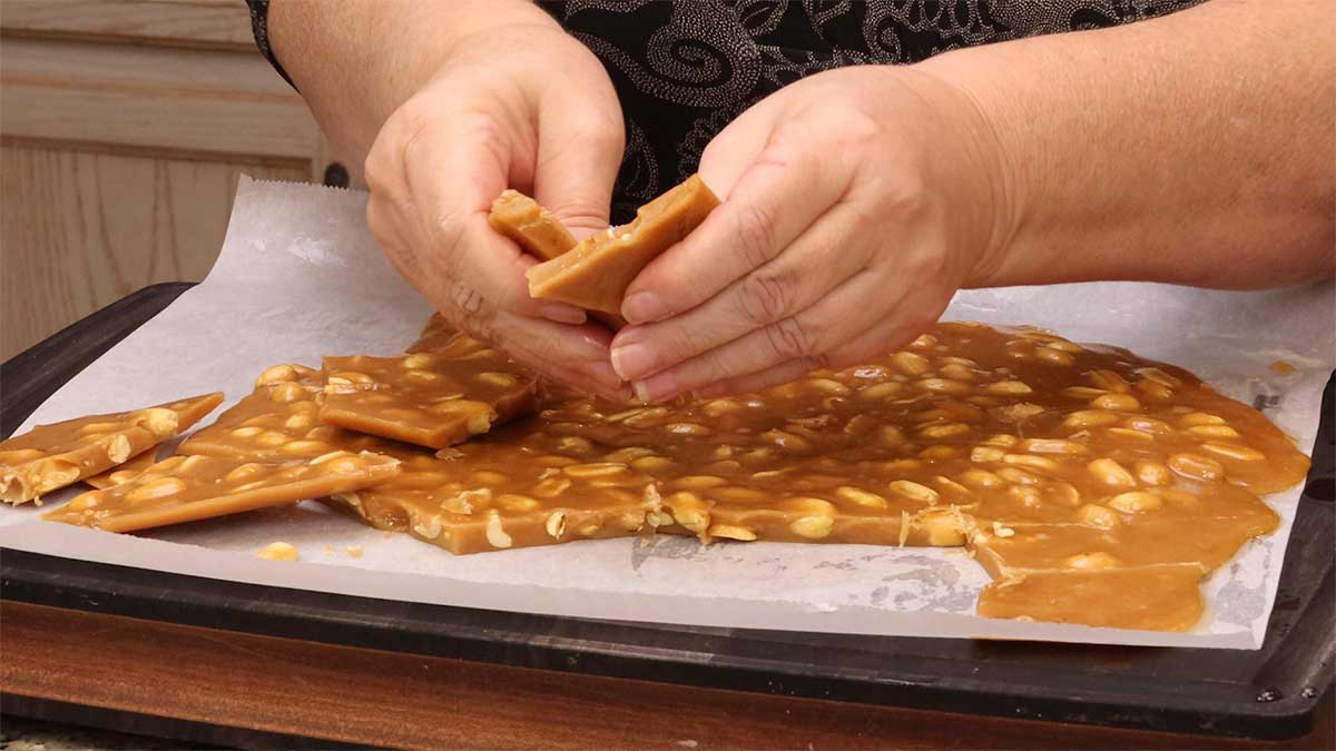 breaking the peanut brittle into pieces