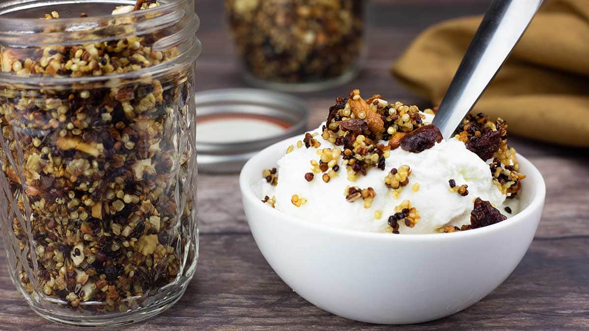 yogurt in a bowl with quinoa granola on top