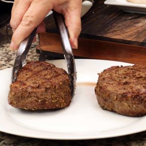 steaks resting on white plate
