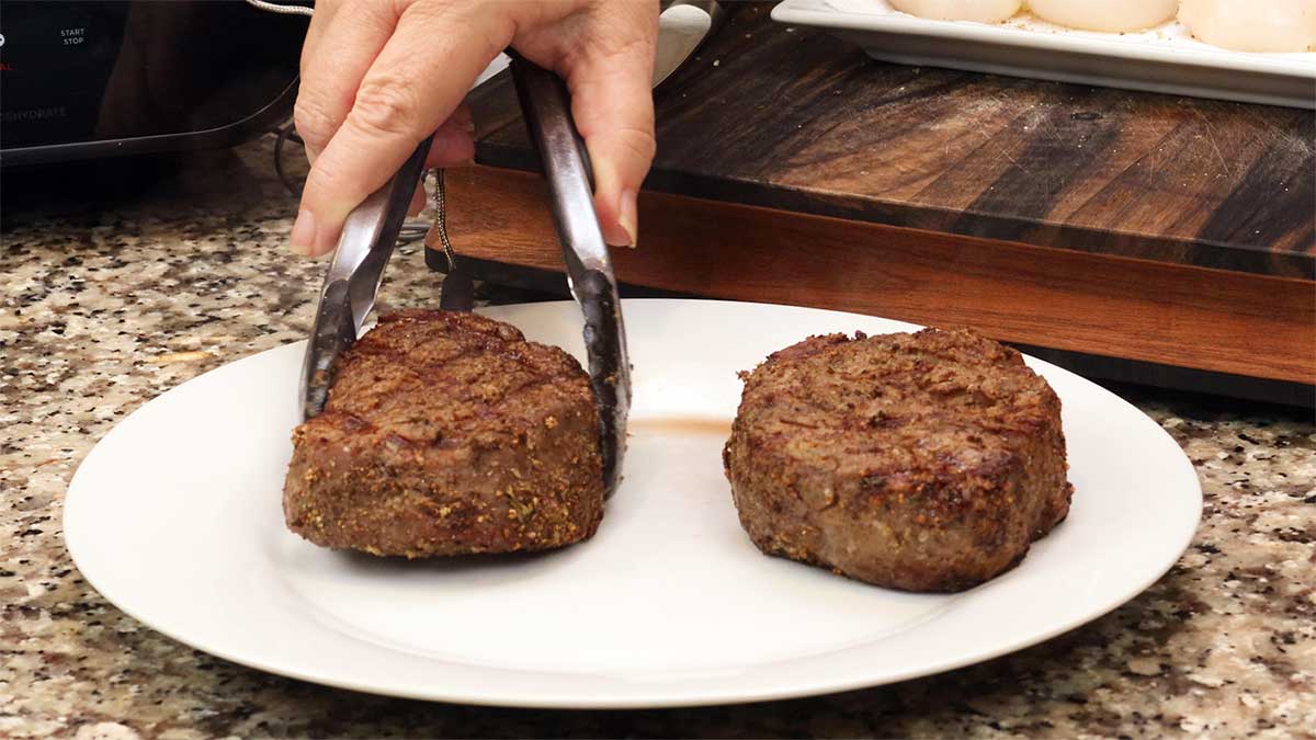 steak resting on white plate