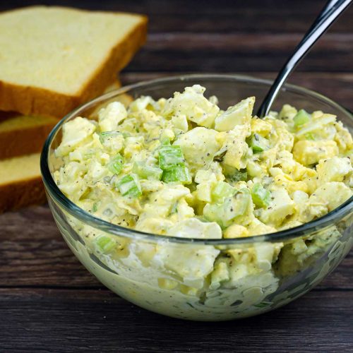 no peel egg salad in a bowl beside bread slices