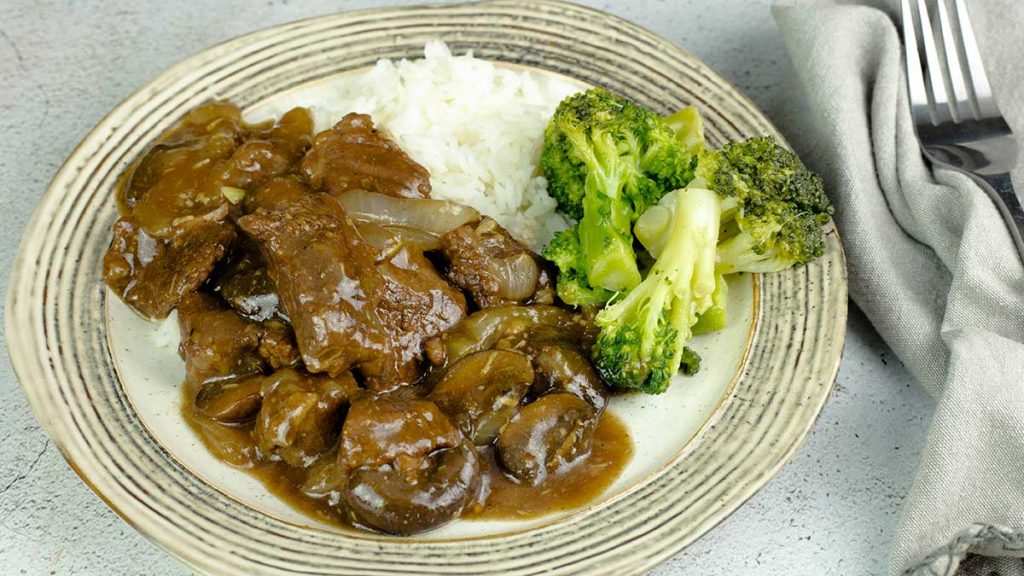 beef tips & rice with broccoli on a plate